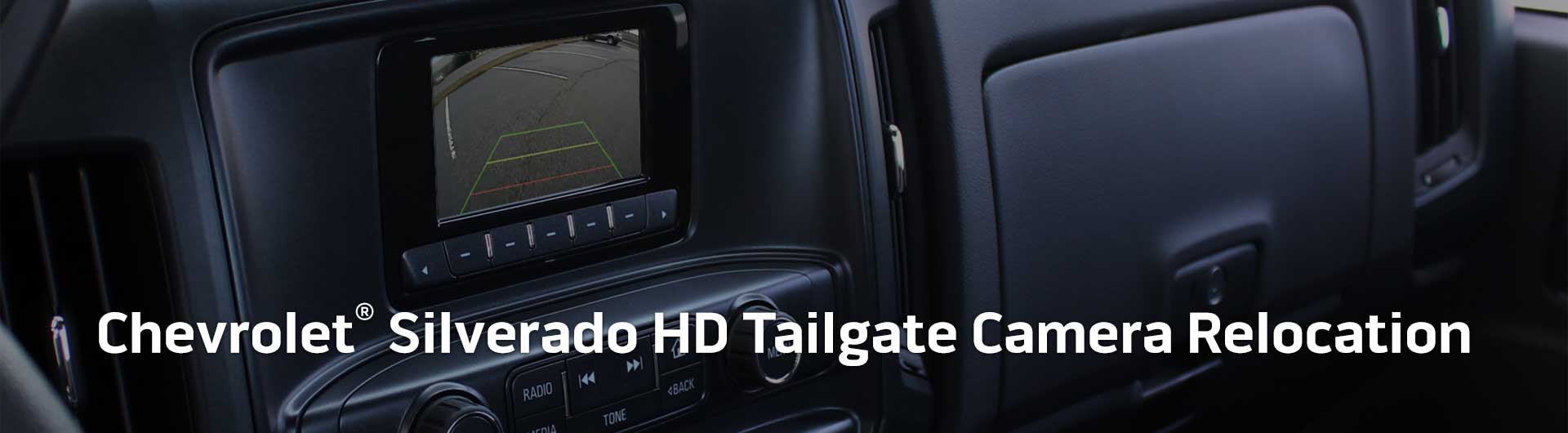 An image showing the dashboard monitor of a Chevrolet Silverado HD with the view from the backup camera on display.