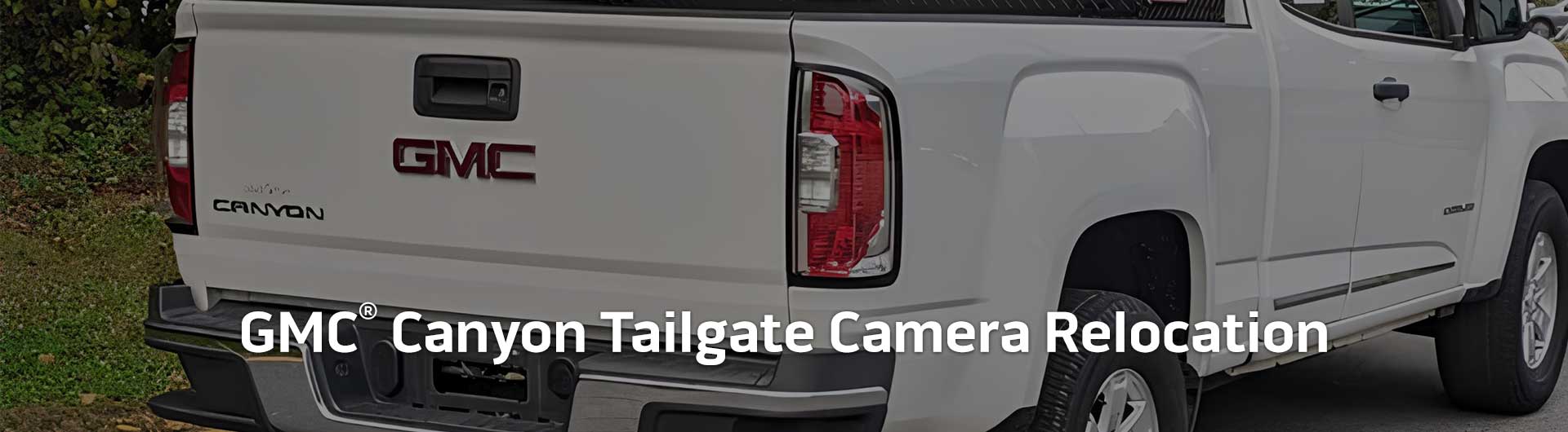 An image showing the tailgate of a GMC Canyon truck. Text overlaid onto the image reads GMC Canyon Tailgate Camera Relocation