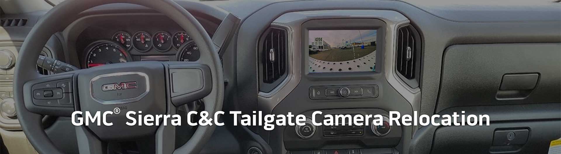 An image showing the dashboard monitor of a GMC Sierra Cab & Chassis Truck with the view from the backup camera on display.