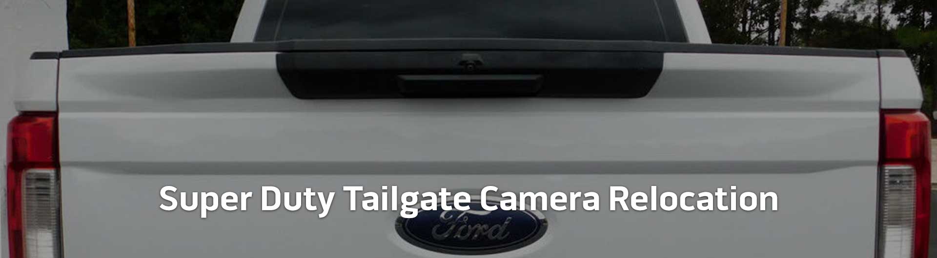 An image showing the tailgate of a Ford Super Duty truck. Text overlaid onto the image reads Super Duty Tailgate Camera Relocation