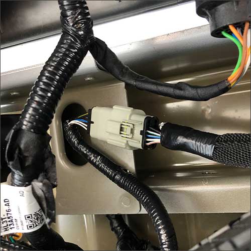 An image of the gray factory camera interface harness for a Ford F-150