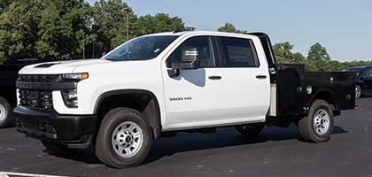 An image showing a white Chevrolet Cab & Chassis truck in a parking lot.